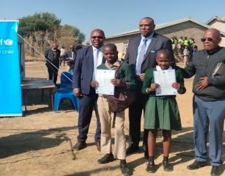 Africa CRVS day celebrations in Lesotho at Assumption Primary school in Berea district: issuance of birth certificates to students. From left to right: Mr. Tumelo Raboletsi-Principal Secretary, Dr. Kimanzi Muthengi- Deputy Representative-UNICEF, Hon. Semper G Masupha-Prinicipal Chief of Ha ‘Mamathe.
